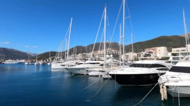 Yachts are moored off the coast with expensive hotels at the foot of the mountains. High quality 4k footage