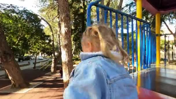 Little Girl Slides Spiral Slide While Holding Railing High Quality — Stock video
