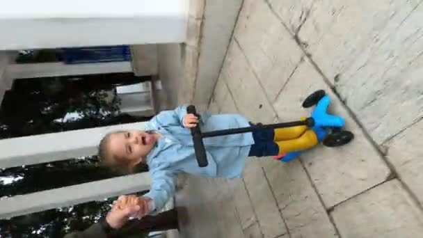 Father Carries Little Girl Catching Raindrops Her Tongue Scooter Yard — Stock video