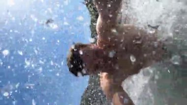 Young man dives under water, swims and emerges. High quality 4k footage