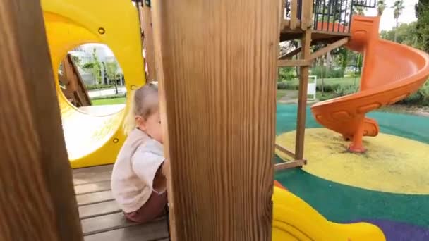 Little Girl Slides Wooden Slide Rubber Flooring High Quality Footage — Stockvideo