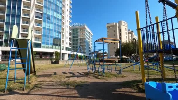 Little Girl Swings Swing Playground Skyscrapers High Quality Footage — Stockvideo