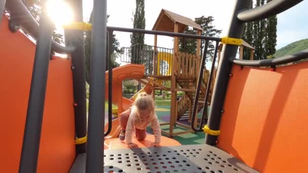 Little Girl Swings Bar Slides Slide High Quality Footage — Stockvideo