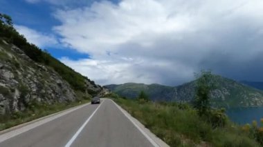 Alpine highway with a tunnel over the blue sea. High quality 4k footage