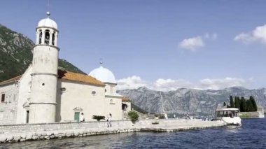 Church of Our Lady on the Rocks on the island against the backdrop of green mountains. Montenegro. High quality 4k footage