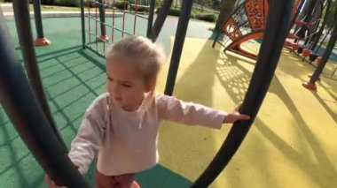 Dad spins a little girl on a vertical standing single carousel. High quality 4k footage