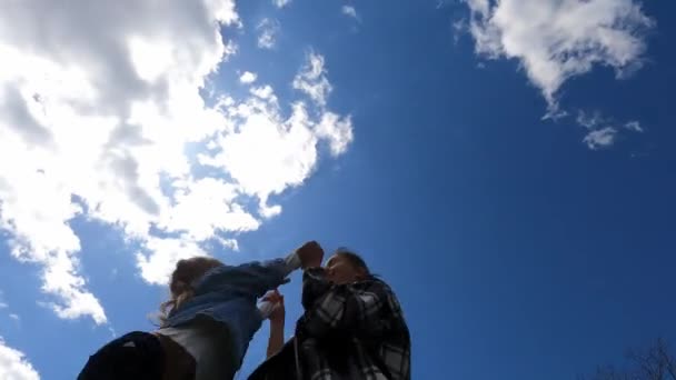 Mom Twists Little Girl Holding Her Hands Background Cloudy Sky — Stockvideo