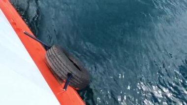 View from the board of the floating ferry to the sea below. High quality 4k footage