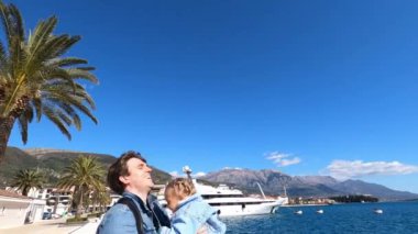 Dad throws up a little girl in his arms while standing on the pier. Slow motion. High quality 4k footage