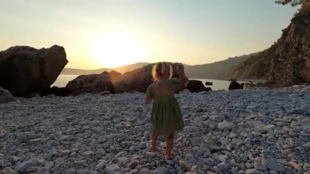 Little Girl Carefully Walks Barefoot Pebbles Large Boulders Seashore High — Stock Video