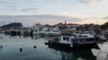 Motor boats at the pier against the backdrop of the sunset sky. High quality FullHD footage