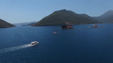 Island of St. George and Gospa od Skrpjela in the sea with mountains in the background. Drone. High quality 4k footage