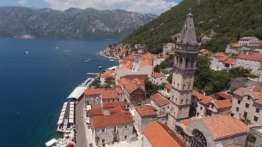 Drone view of the bell tower and the church of St. Nicholas on the seashore. Perast, Montenegro. High quality 4k footage