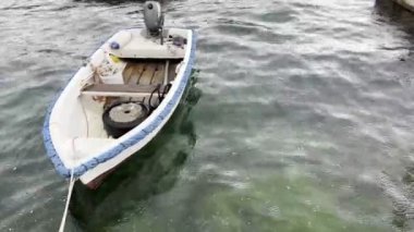 Fishing boat with a motor moored to the shore. High quality 4k footage