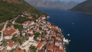 Yacht sails from the pier of the resort town of Perast. Montenegro. High quality 4k footage