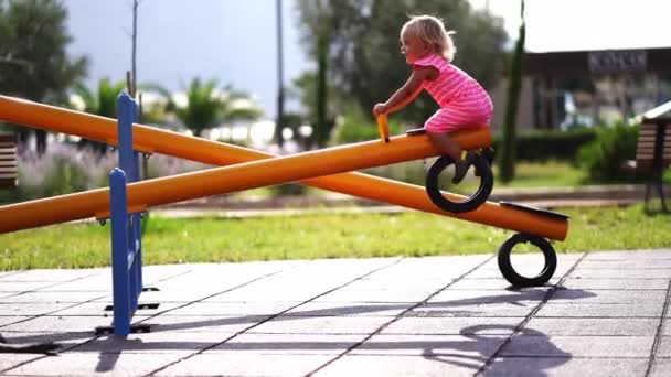 Little Girl Swinging Swing Balancer Holding Handle Playground High Quality — Stockvideo