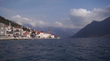 View from the sea to the ancient town of Dobrota at the foot of the mountains. Montenegro. High quality FullHD footage