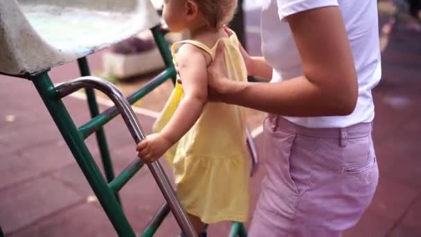 Mom Helps Little Girl Climb Stairs Slide High Quality Fullhd — Stockvideo