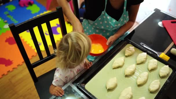 Little Girl Watching Mom Beat Eggs Fork Bowl Dipping Buns — Stockvideo