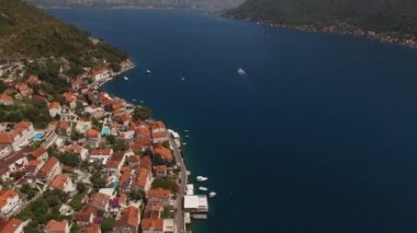 Swimming pools next to the old houses of Perast. Drone. High quality 4k footage