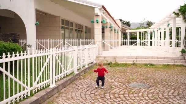 Little Girl Runs Waving Her Hands Paving Stones Pergola Garden — Stock video
