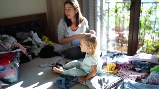 Little Girl Sits Next Her Mother Folding Laundry Washing Twitches — Stock video