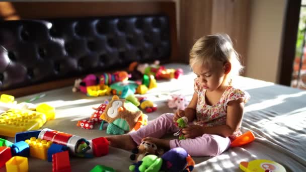 Little Girl Plays Plush Dragon Sitting Many Toys Bed High — Wideo stockowe
