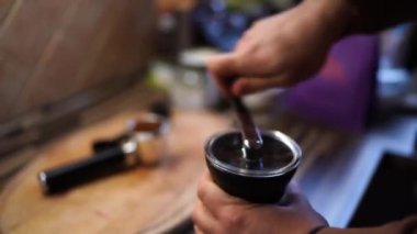 Man grinds coffee in a hand grinder. High quality 4k footage