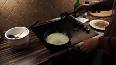 Chef turns the ruddy pancake on the other side with a spatula. High quality 4k footage