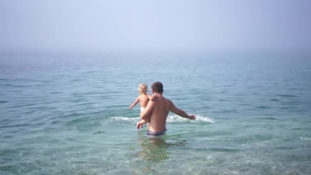 Dad Teaches Little Girl Swim Sea Holding Her Stomach High — Stock video