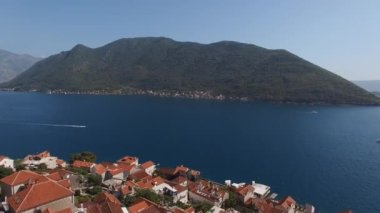 View of the Bay of Kotor above the red roofs of houses in Perast. Drone. High quality 4k footage