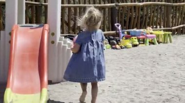 Little girl throws the ball into the basketball basket at the playground. High quality 4k footage