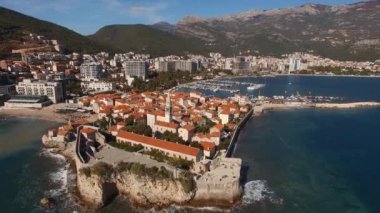 Ancient bell tower among stone houses in old Budva. Montenegro. High quality 4k footage
