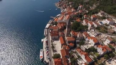 Bell tower of the Church of St. Nicholas in Perast overlooking the Bay of Kotor. Drone. High quality 4k footage
