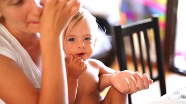妈妈抱着一个小女孩 双手放在桌上吃坚果 高质量的4K镜头 — 图库视频影像