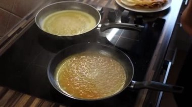 Cook reduces the heat of boiling pans on the stove. High quality 4k footage