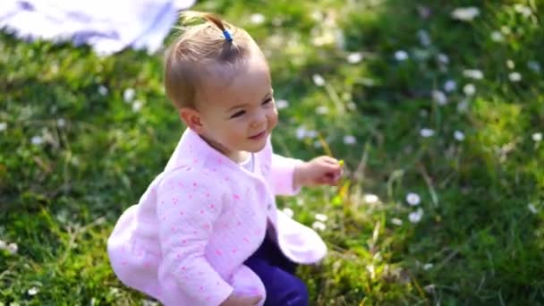 Little Girl Squatting Green Lawn Holding Small Flower Her Hand — Stock videók