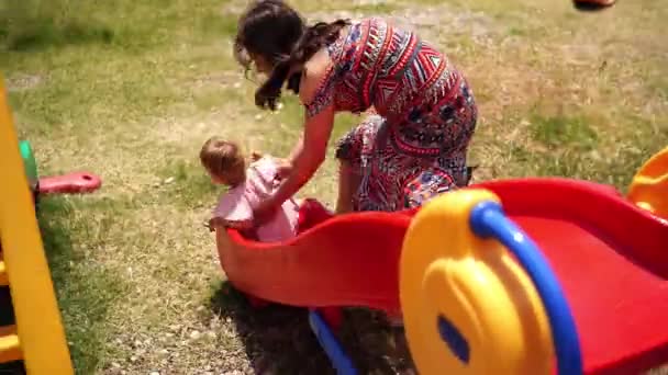 Mom Helps Little Girl Slide Playground High Quality Footage — Vídeo de Stock