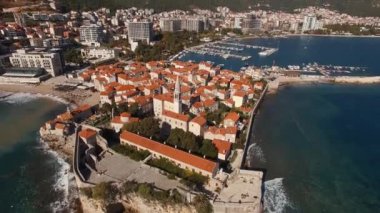 Old Budva on the peninsula against the background of the new town. Montenegro. High quality 4k footage