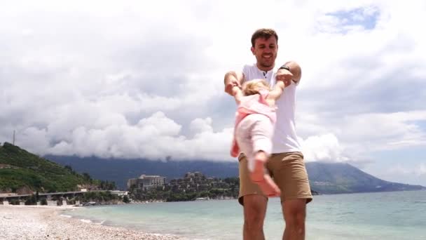 Smiling Dad Spins Little Girl Arms While Standing Beach Slow — Wideo stockowe