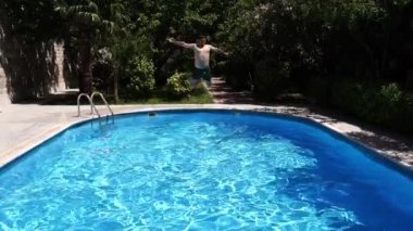 Man jumping into the pool like a cannonball. High quality FullHD footage