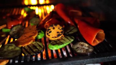 Sliced vegetables are cooked on a grill over a fire. High quality 4k footage