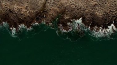 Sea waves roll on a rocky shore. Drone. High quality 4k footage