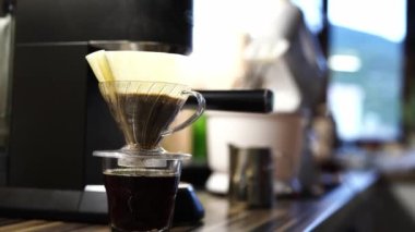 Coffee being filtered in a pour over coffee machine on the table. High quality 4k footage