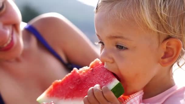 Little Girl Nibbles Piece Watermelon Next Her Mother High Quality — Wideo stockowe
