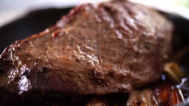 Light steam over a piece of roast beef with vegetables. High quality 4k footage