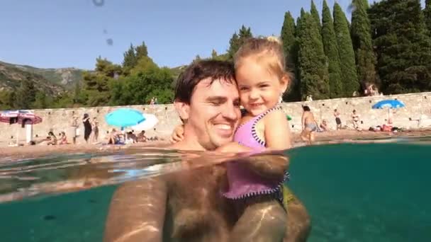 Усміхнений Тато Маленькою Дівчинкою Руках Стоїть Морі Тлі Пляжу Високоякісні — стокове відео