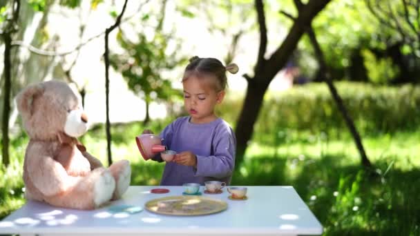 Little Girl Teddy Bear Playing Tea Party Table High Quality — Stock Video