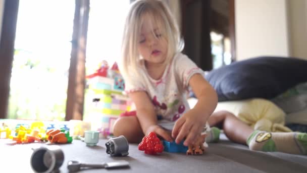 Little Girl Playing Lego Figures Bed High Quality Footage — Stock Video