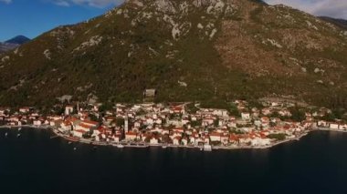 Kotor Körfezi kıyısında, dağların eteğindeki Perast sahilinde. Drone. Yüksek kalite 4k görüntü